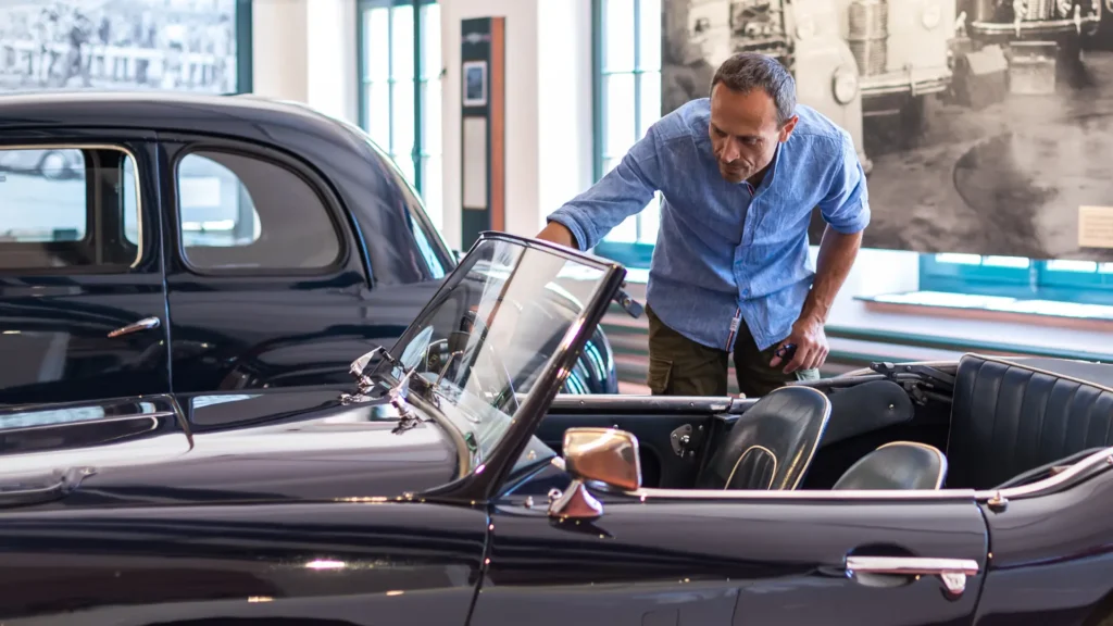 Adrian at Emil Frey with the car - Career Reinvention in Switzerland