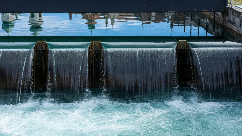 Water cascading over a weir, symbolizing the flow of effective communication and avoiding resistance.