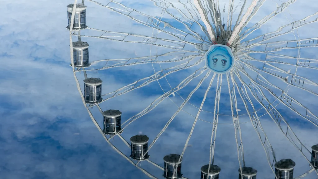 A blue ferris wheel against a clear sky, symbolizing different perspectives in workplace communication.