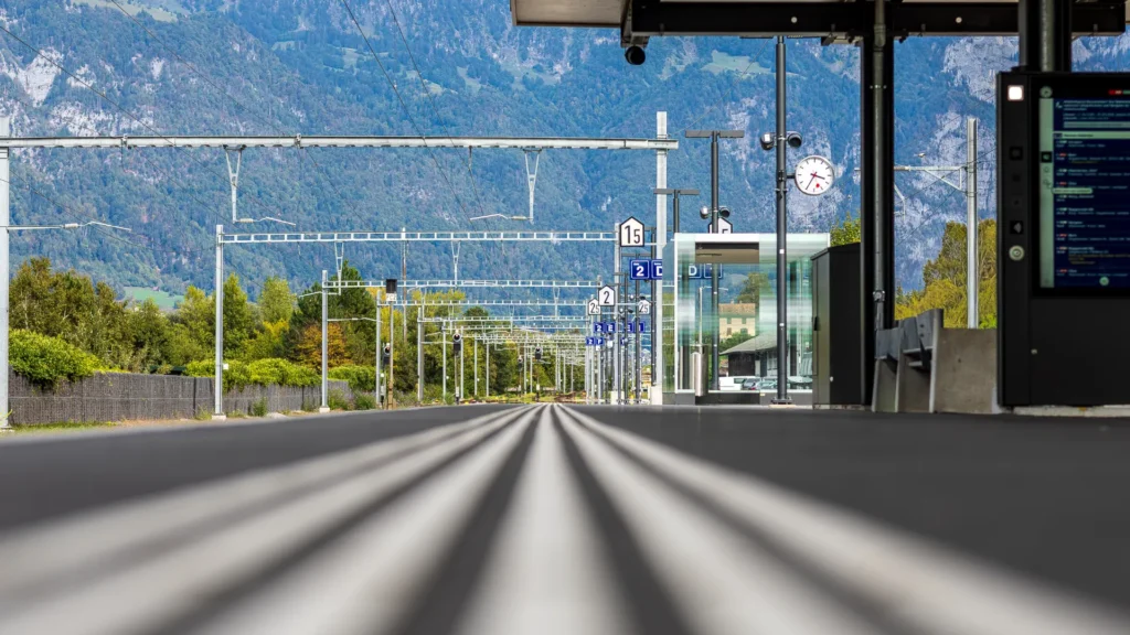 A railway track leading towards the Swiss mountains, illustrating the journey of adapting to a new professional culture.