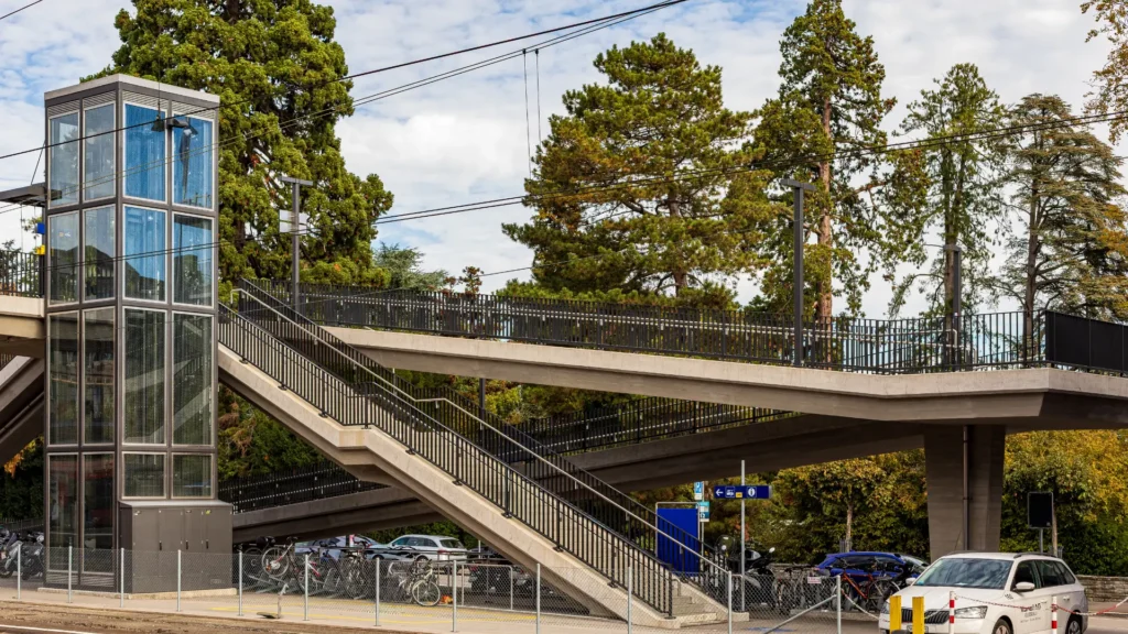 An empty Swiss train platform with the Alps in the background, symbolizing the professional journey of relocating to Switzerland.